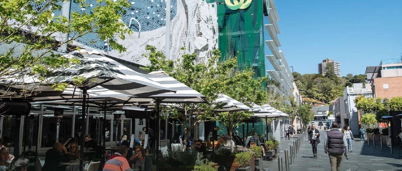 Kiaora Lane, Double Bay — outdoor dining under striped umbrellas on a pedestrianised laneway